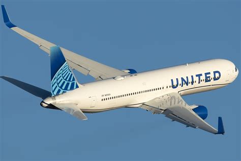 united airlines boeing 767 taking off from venice marco polo airport with cityscape in background