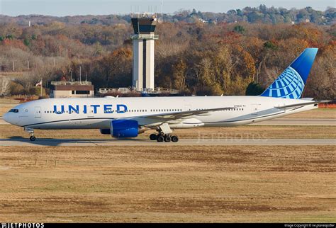 United Airlines Boeing 777 captain walking across airport ramp before transpacific departure