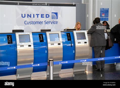 United Airlines customer service counter at Beijing Capital International Airport crowded with rebooking passengers