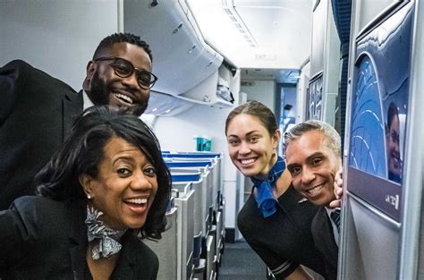 United Airlines flight attendants holding placards demanding fair pay outside airport