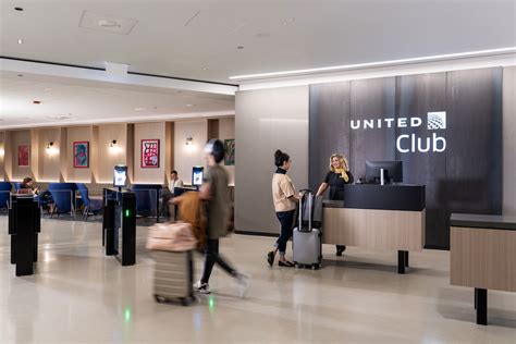 United Airlines United Club staff assisting travelers at full-service desk SFO Terminal 3