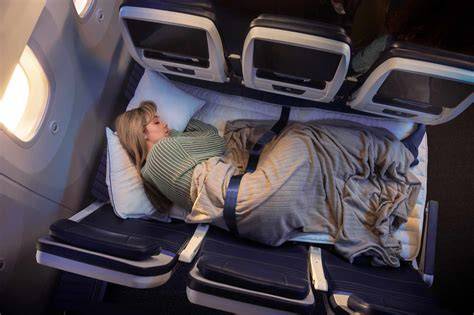United Airlines widebody economy cabin showing Relax Row mattress setup with pillows and blanket