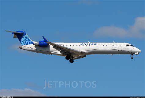 United Express CRJ-550 preparing for departure at ORD as American Eagle E175 taxis nearby