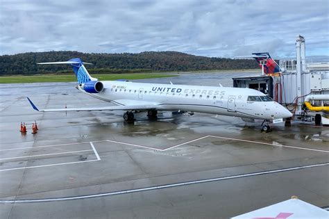 united express regional jet taxiing at smaller u.s. airport with sunset background