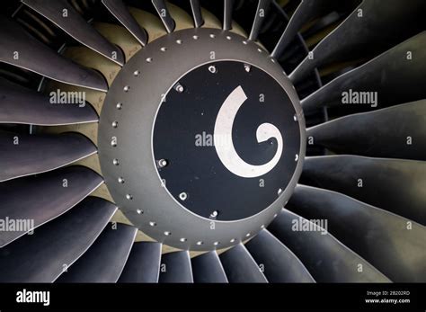 up-close jet engine spinner showing painted spiral and turbine fan