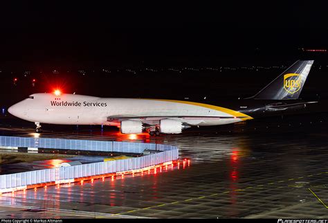 UPS Boeing 747-8F cargo aircraft loading freight at night hub