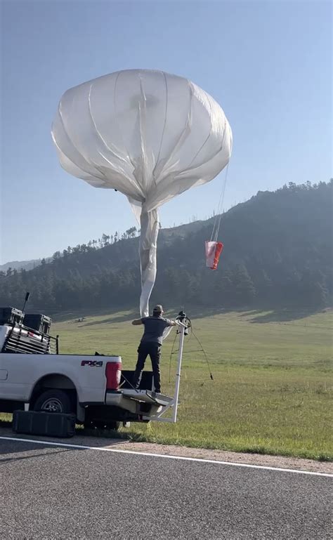 Urban Sky Microballoon over wildfire-affected terrain gathering imagery