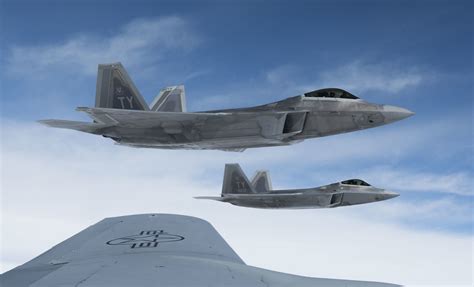US Air Force F-22 Raptor flying alongside F-15 Eagle formation
