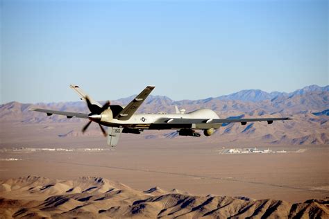 US Air Force MQ-9 Reaper military drone armed with AGM-114 Hellfire missiles on runway