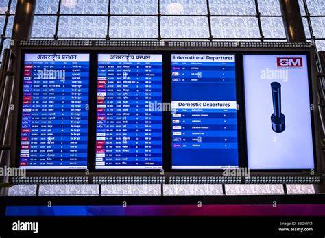 US airport departure board showing domestic flight delays and passengers waiting at gate