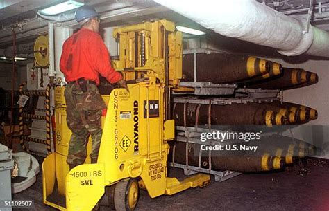 US Navy Aviation Ordnanceman handling aircraft weapons carrier magazine