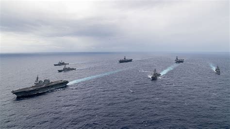 us navy carrier strike group in contested pacific waters during high tension deployment