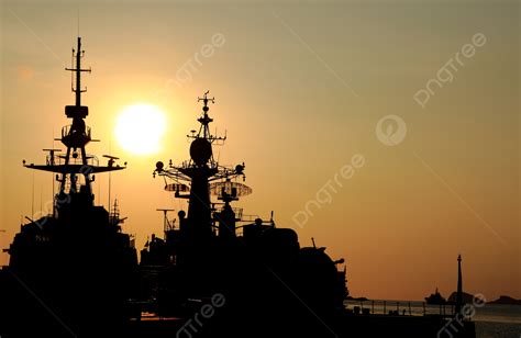 US Navy destroyer silhouette against sunset after long-range missile launch