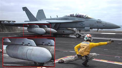 US Navy EA-18G Growler electronic warfare aircraft carrying ALQ-99 jamming pods and anti-radiation missiles on a flight line