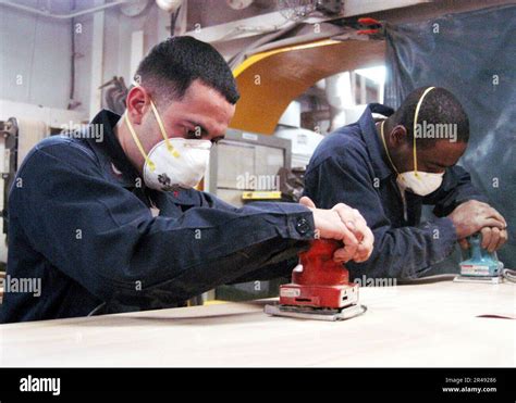 US Navy Hull Maintenance Technician welding aircraft carrier repairs