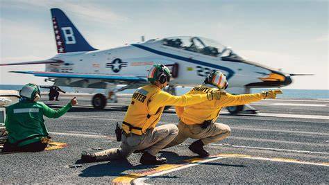 US Navy T-45 Goshawk carrier-capable jet trainer performing a low pass near a naval aviation training airfield