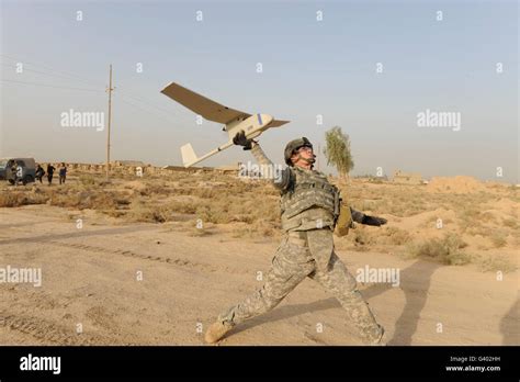 US soldier launching RQ-11 Raven drone in active combat training