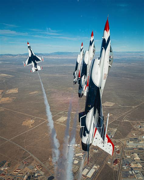USAF Thunderbirds F-16C in red-white-blue livery performing diamond formation during airshow at Nellis AFB
