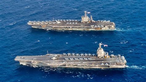 USS Enterprise alongside USS Gerald R. Ford showing generational carrier comparison