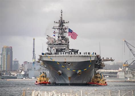 USS Tripoli sailing alongside supply ship during maritime logistics operation