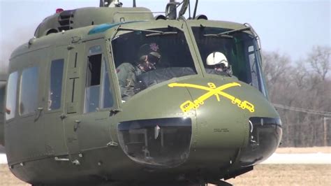 veteran pilot beside restored UH-1H Huey helicopter