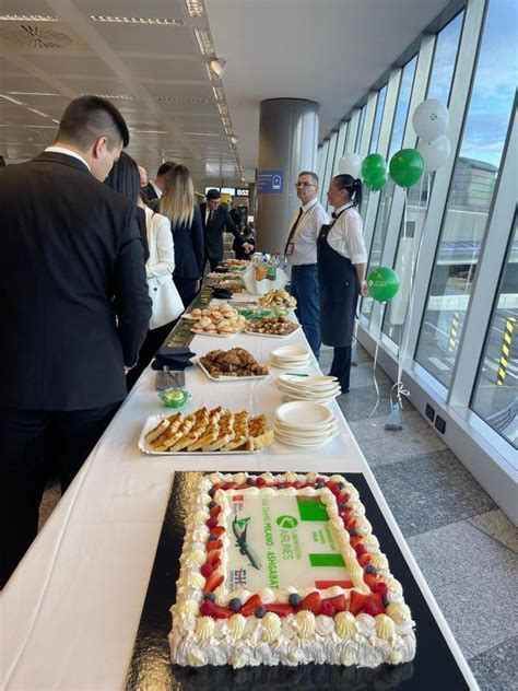vietnam airlines crew welcoming inaugural flight passengers in milan malpensa