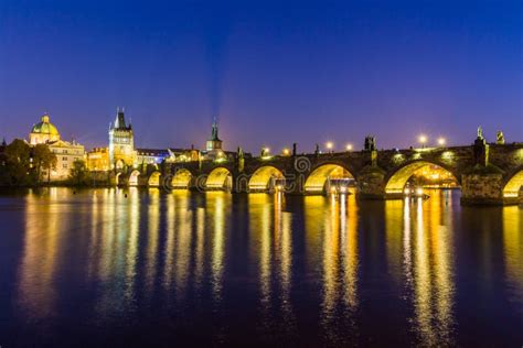 View of Charles Bridge and Prague Castle at sunset from Vltava River embankment