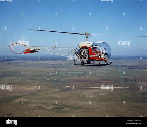 vintage Bell 47 helicopter flying over South Carolina countryside