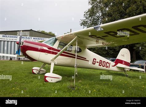 Vintage Cessna 140 parked on a grass airfield
