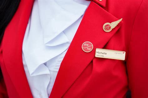 Virgin Atlantic cabin crew in Vivienne Westwood uniforms with pronoun badges