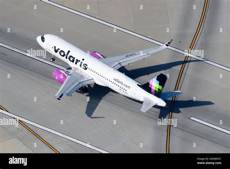 Volaris A320neo departing at dawn with enhanced livery for sustainability campaign