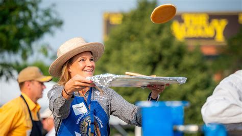 volunteers flipping pancakes at cheyenne frontier days community breakfast