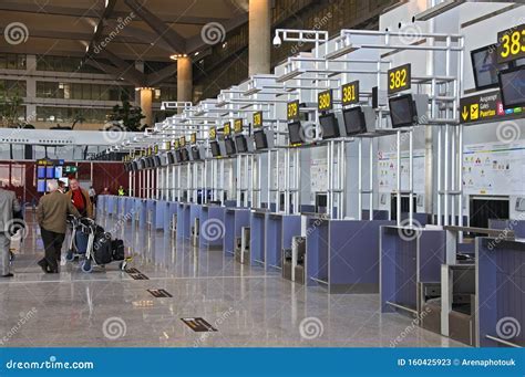 vueling check-in desk at malaga airport with long passenger queue