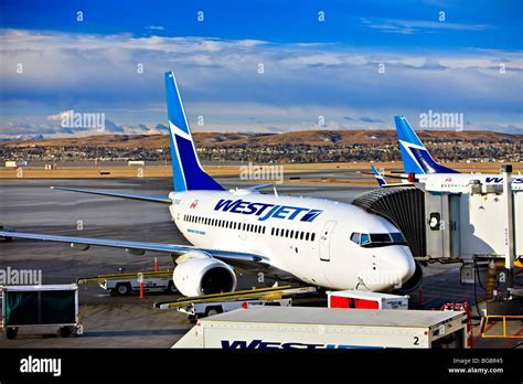 WestJet aircraft on Calgary International Airport apron under stormy skies