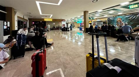 WestJet passengers waiting at airport terminal during potential flight disruption