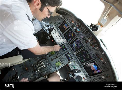 widebody aircraft captain preparing cockpit systems on long-haul jet