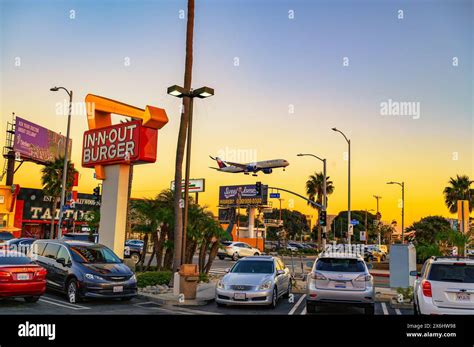 Widebody aircraft landing over In-N-Out Burger near Los Angeles International Airport