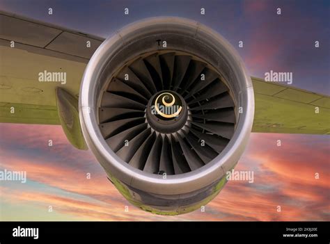 widebody jet engine close-up large turbofan blades airport runway sunset