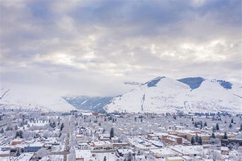 winter view of missoula downtown with surrounding rocky mountains and snowfields
