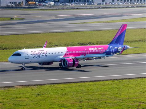 Wizz Air Airbus A321neo aircraft in its pink and purple livery taking off