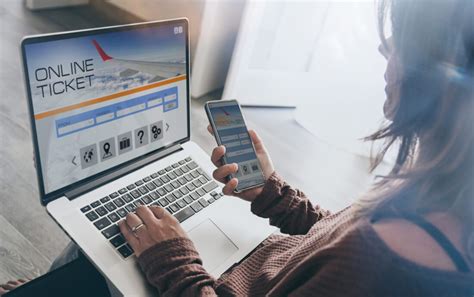 Woman comparing flight prices on a laptop and smartphone