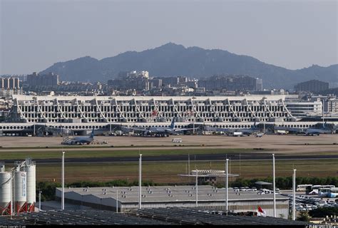 Xiamen city skyline and Xiamen Gaoqi International Airport terminal exterior