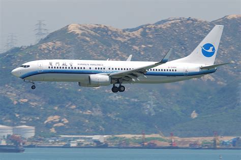 XiamenAir Boeing 737-800 aircraft on runway in rainy conditions