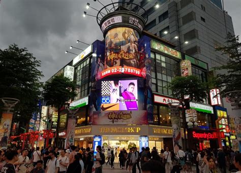 Ximending district with vibrant signage and street performers