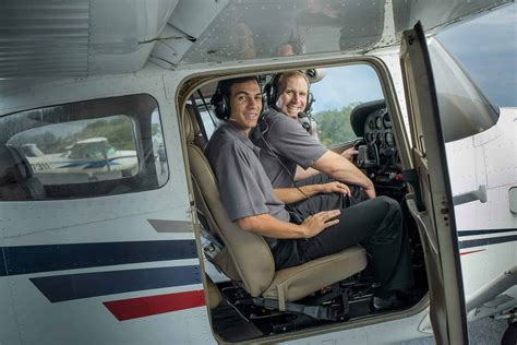 young flight instructor with training aircraft at uk airfield