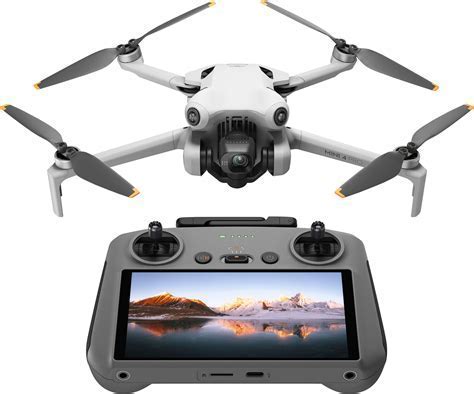 young pilot flying drone with controller featuring built-in screen