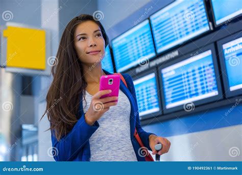 young traveler checking monthly payments on smartphone at airport